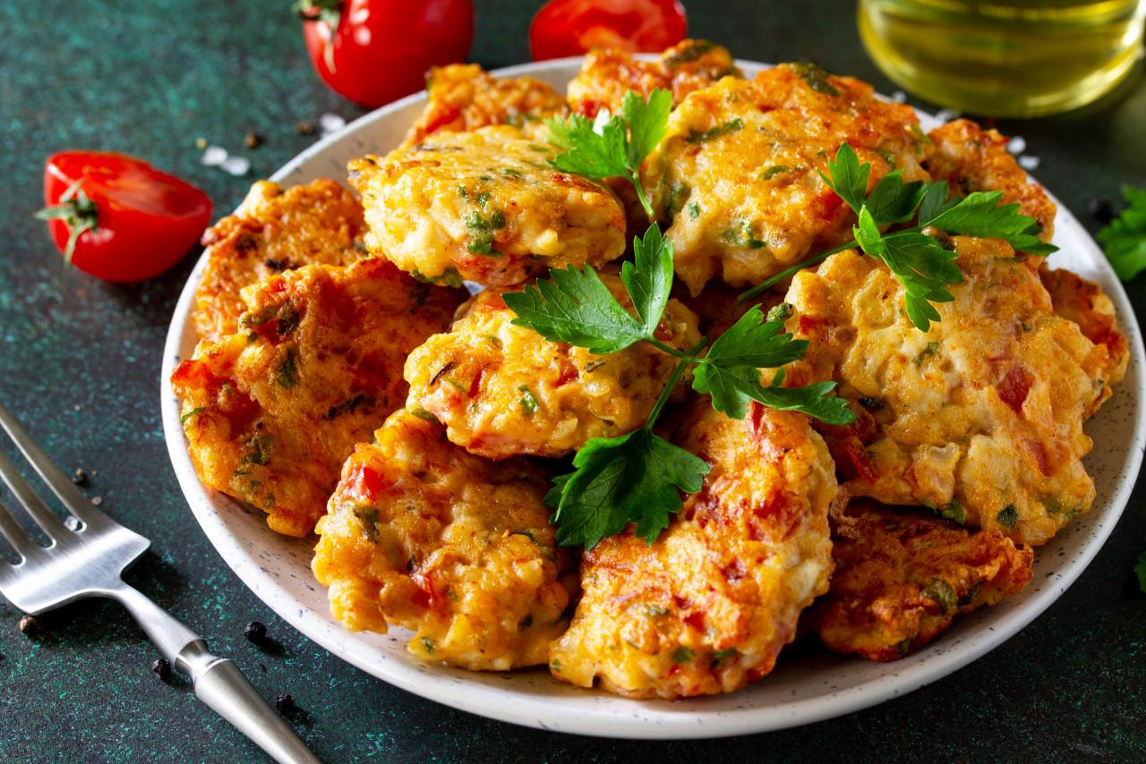 chicken cutlets made from minced meat with paprika tomatoes greens dark stone table
